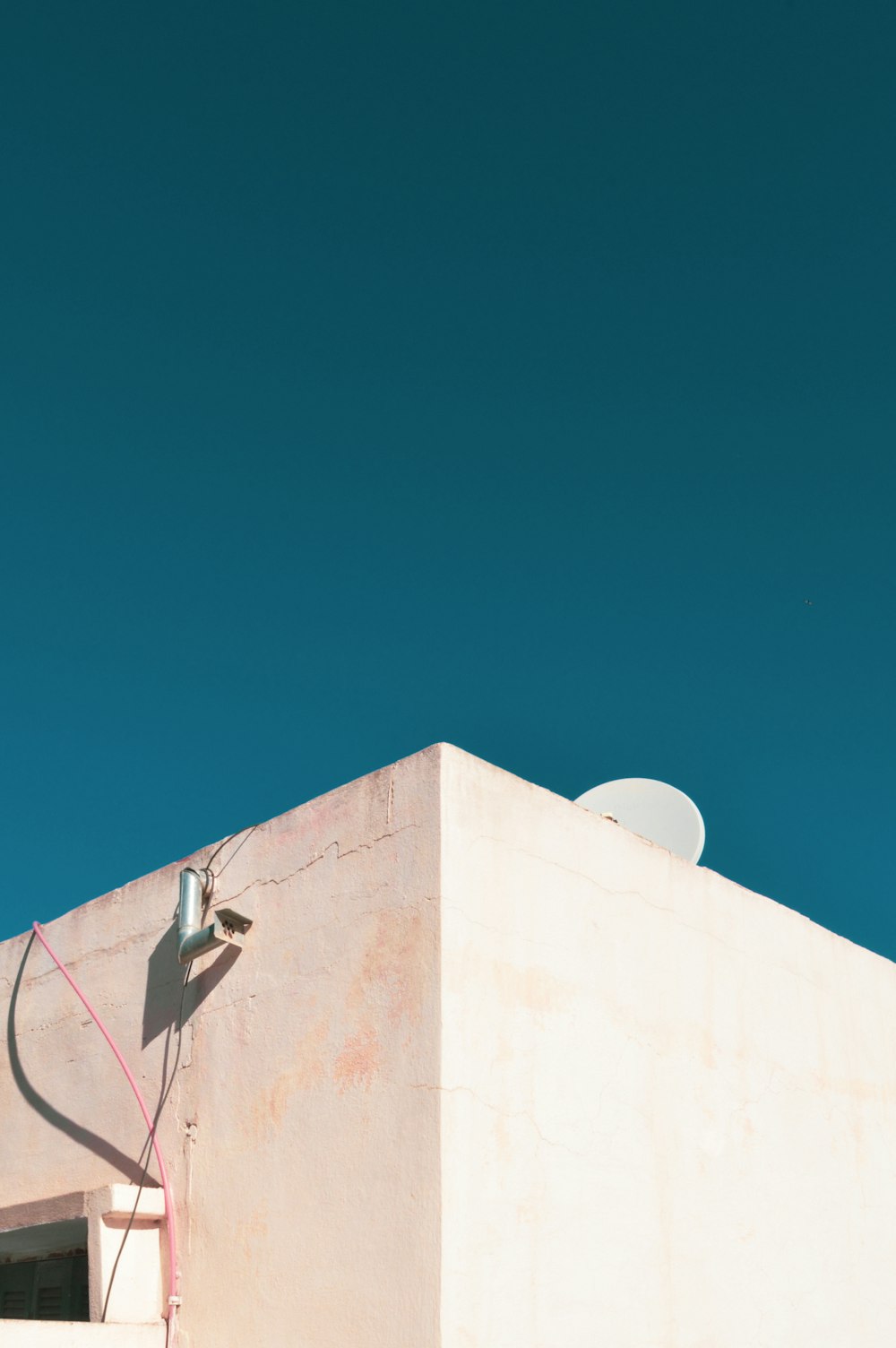 a white building with a satellite dish on top of it