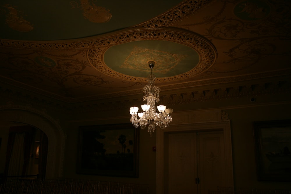 gray uplight chandelier inside room