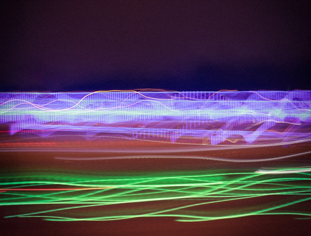 a blurry photo of a building with green and purple lights