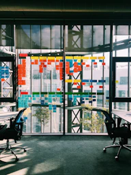 black rolling armchair under white table