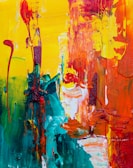 Close-up shot of a canvas with vibrant, swirling colors in motion.