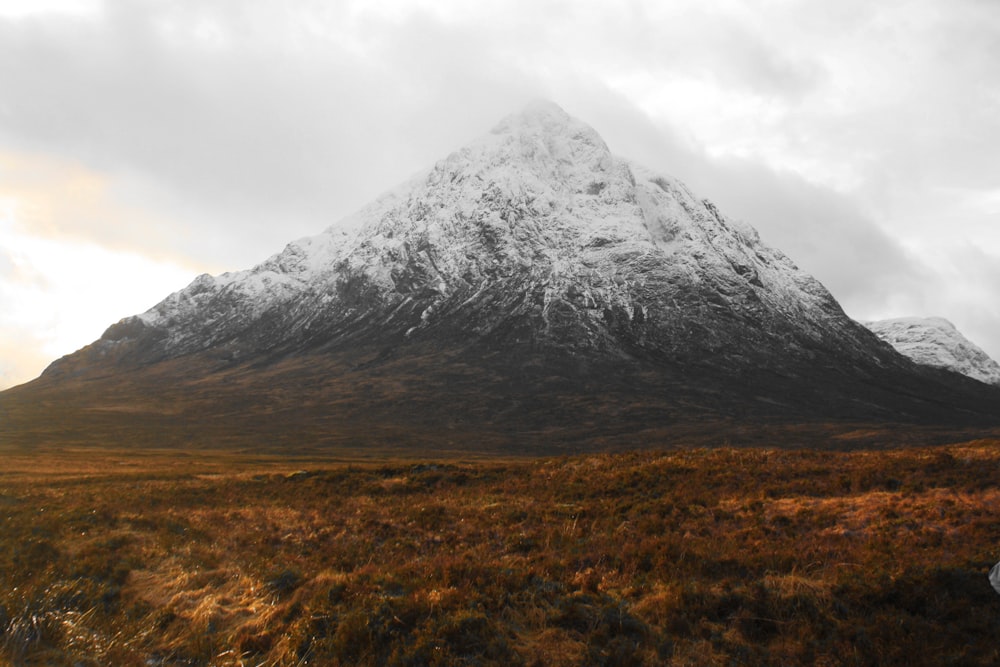 snow capped mountains under white sky