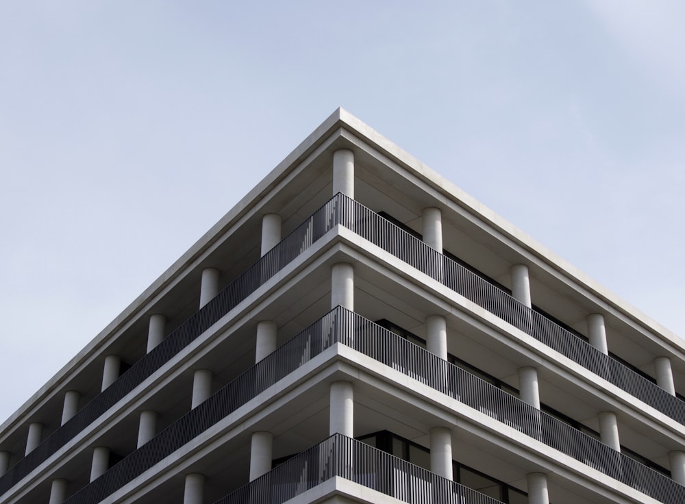 low-angle photography of white and gray concrete multi-story building under clear sky during daytime