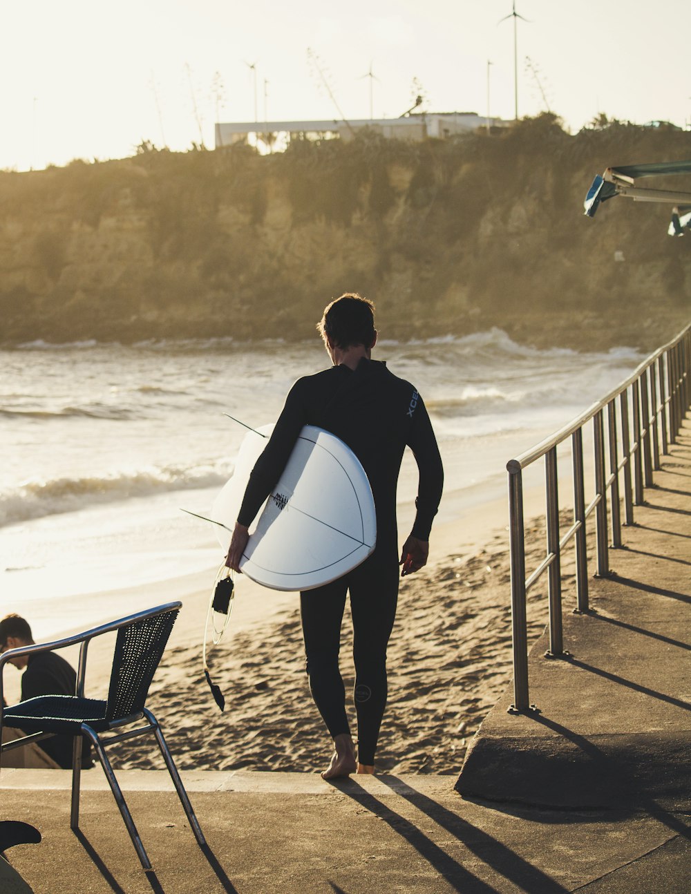 man carrying surfboard during daytime