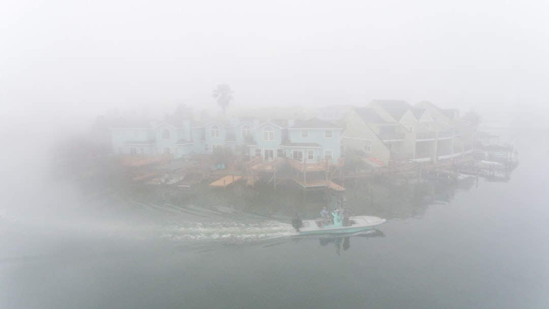 Home and boat in fog in a bay in Corpus Christi