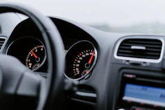 black vehicle dashboard with speedometer on 100