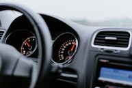 black vehicle dashboard with speedometer on 100