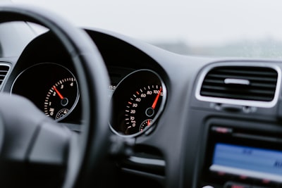 black vehicle dashboard with speedometer on 100