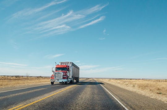 trailer truck passing on road during daytime in Texas United States