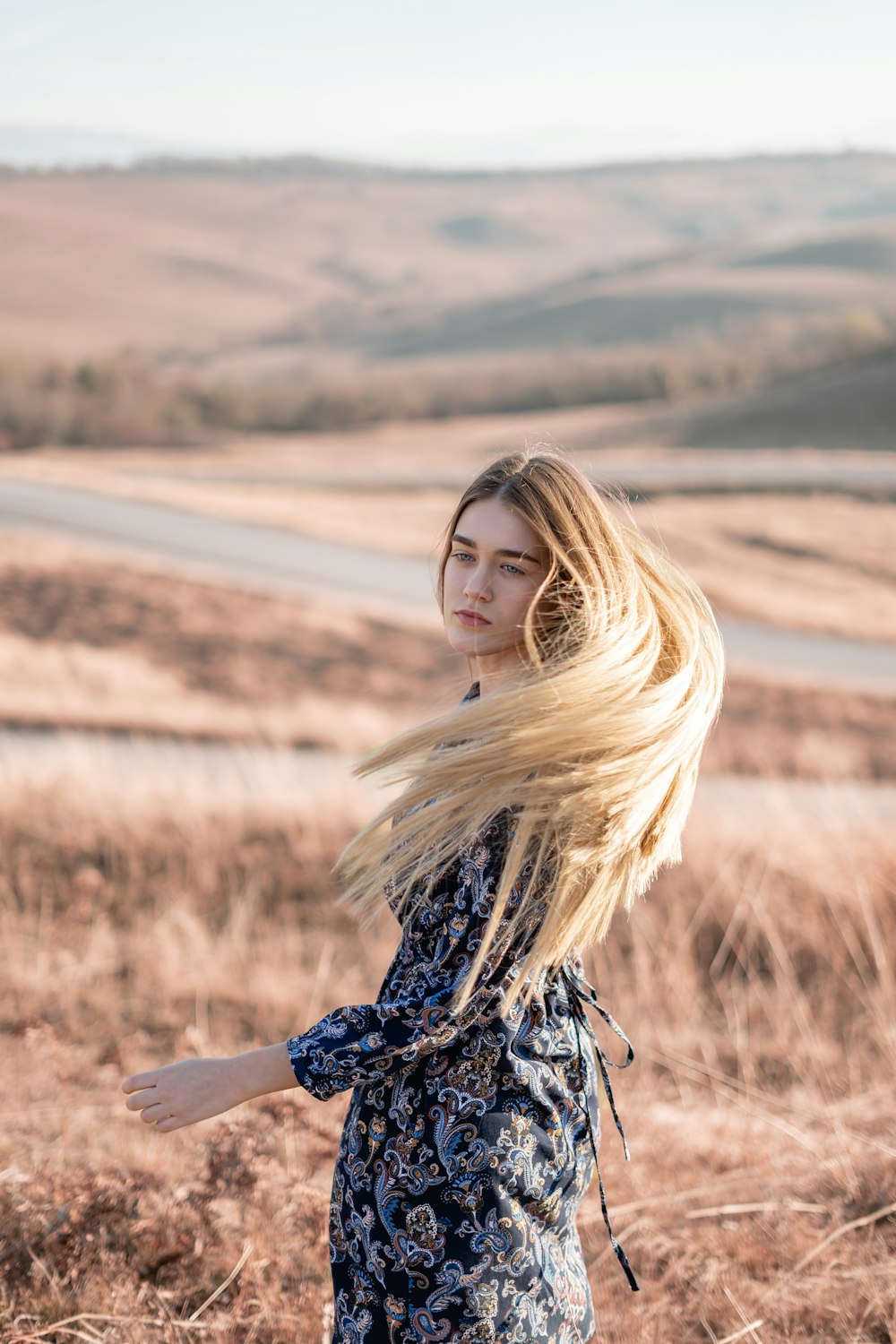 woman standing in brown field