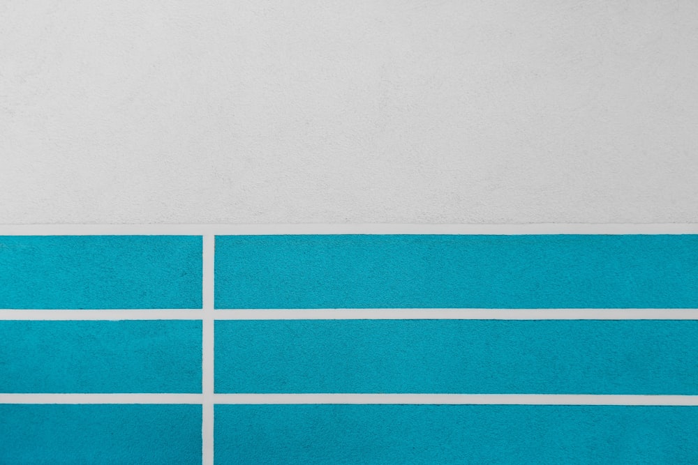 a blue and white wall with a clock on it