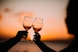 silhouette photography of two person holding long-stem wine glasses