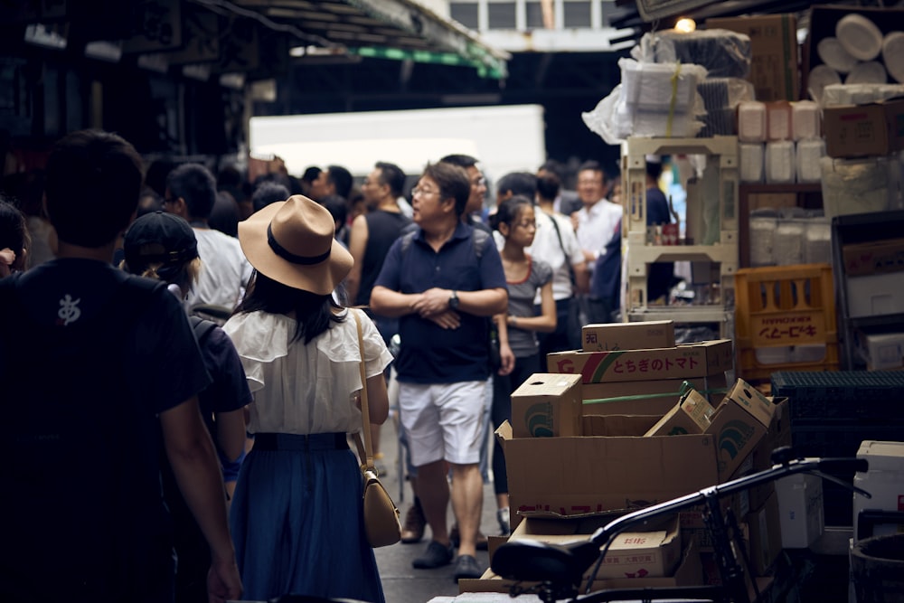people walking on street near cardboard boxes during daytime