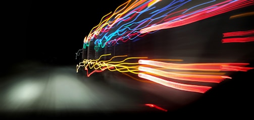 Creative RGB light trails blending over a set of photographed items.