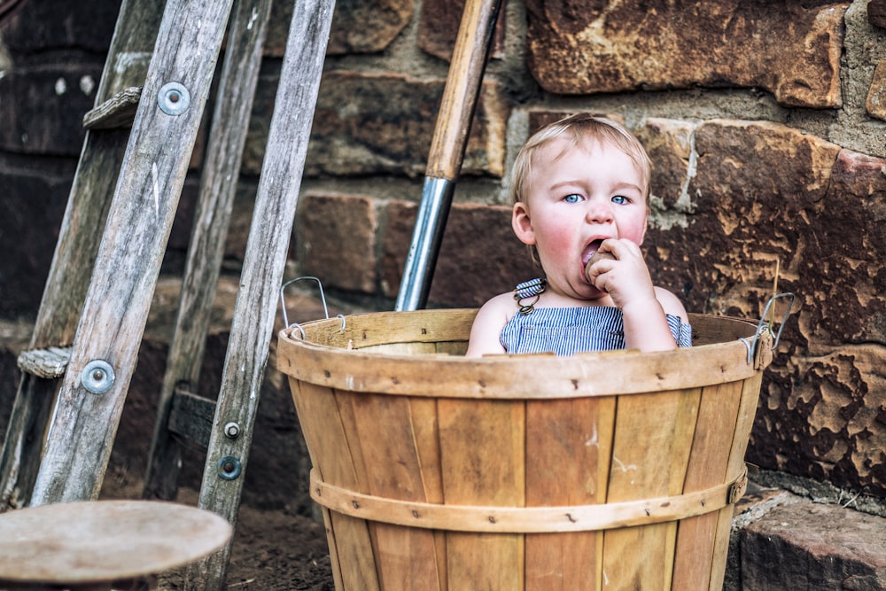 girl in brown wooden bucket