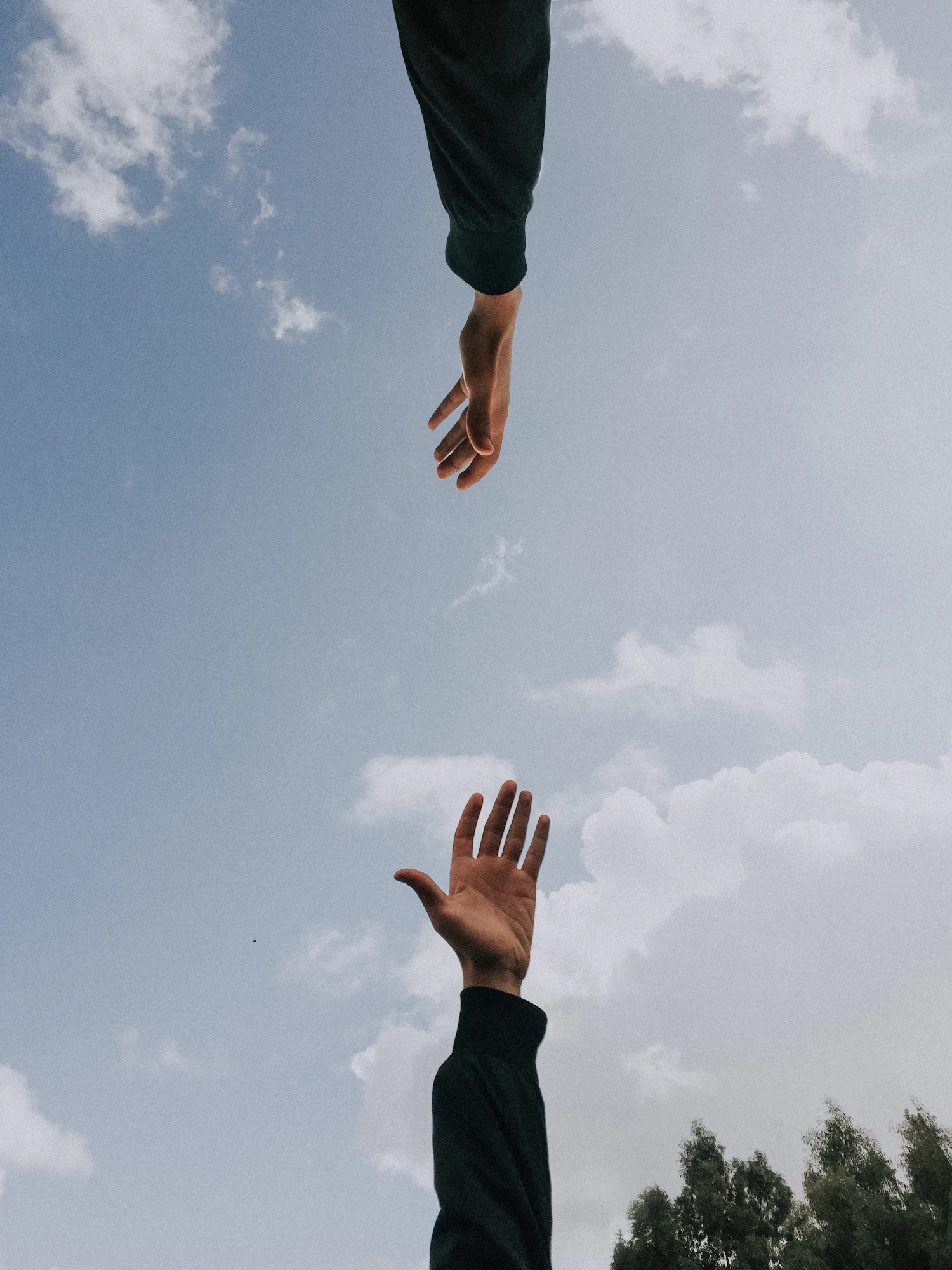 One person supporting another person's forearm during a clinical interaction