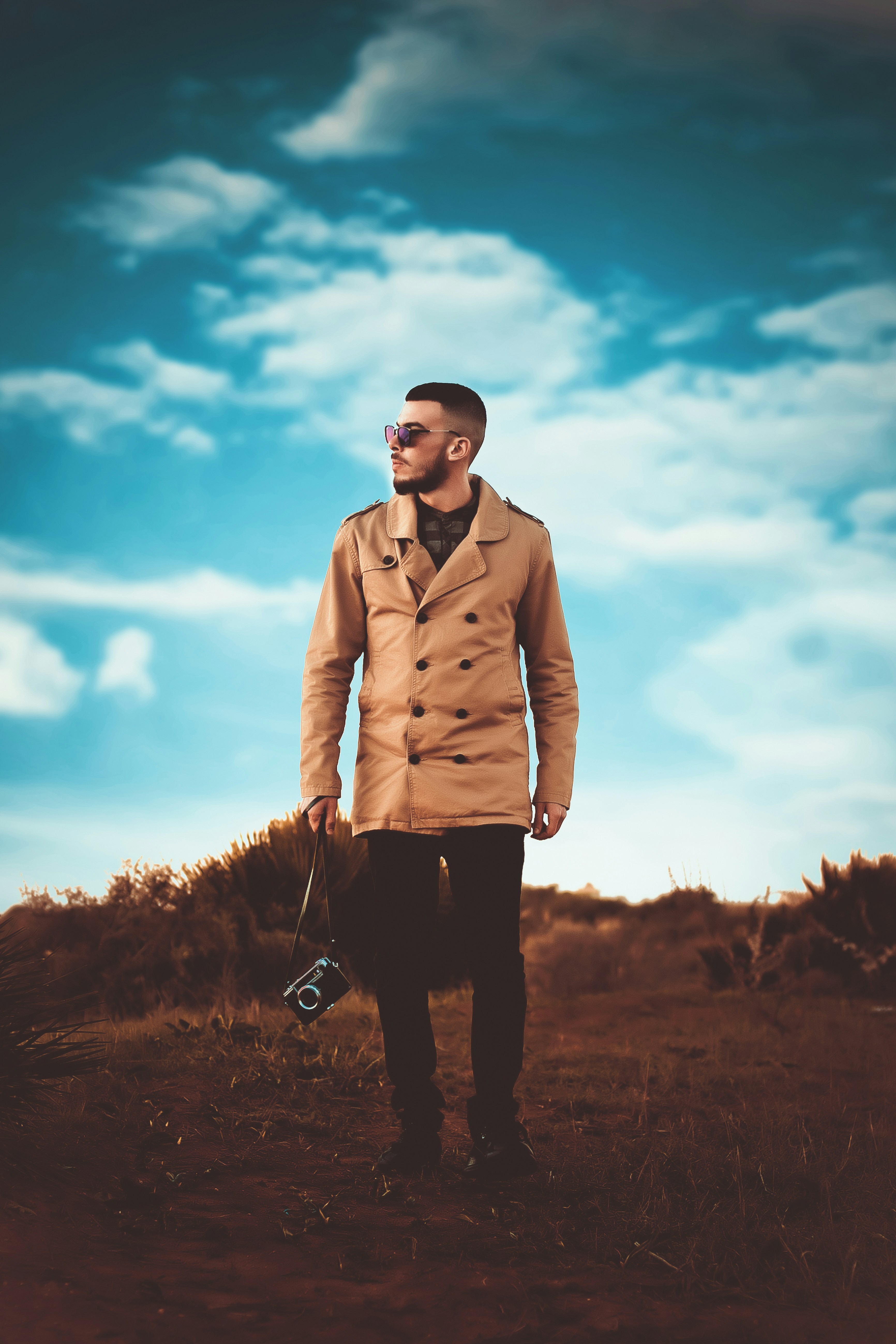 man wearing brown peacoat standing on the field