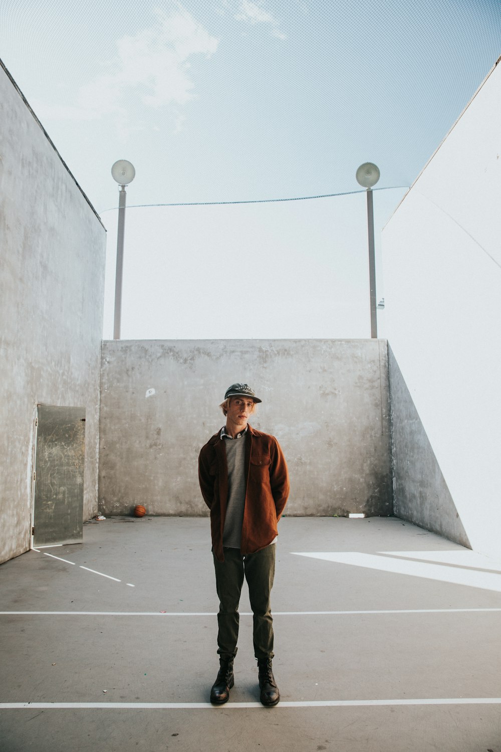 man in brown jacket by walls