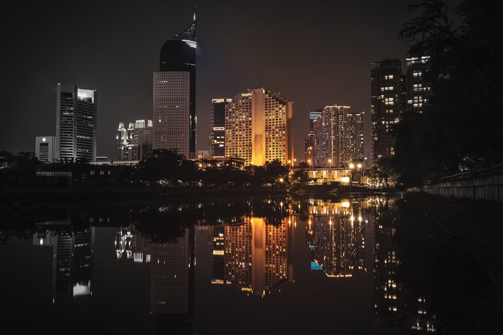 buildings near body of water at night