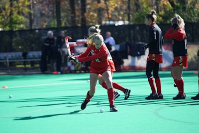 A training session with young athletes practicing field hockey.