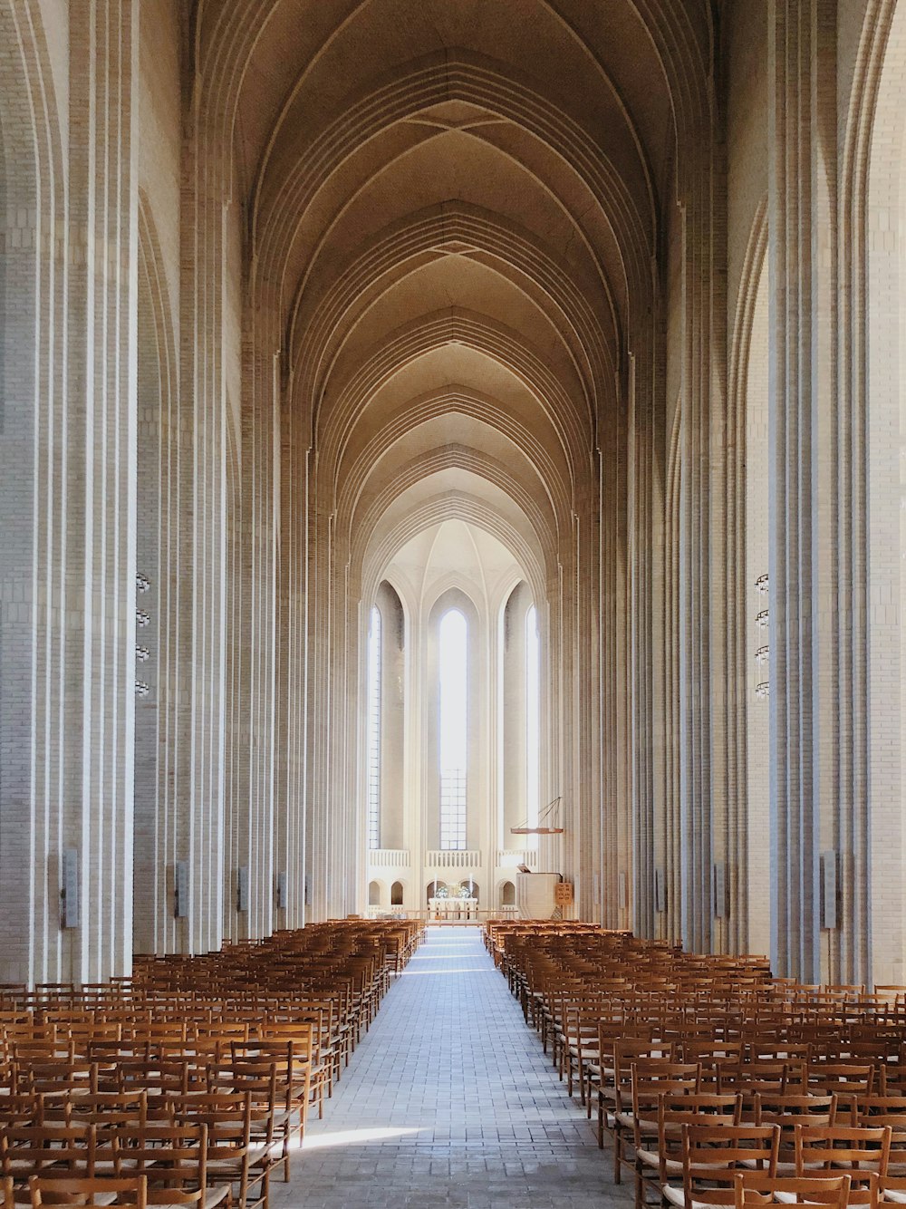a large cathedral with rows of wooden chairs