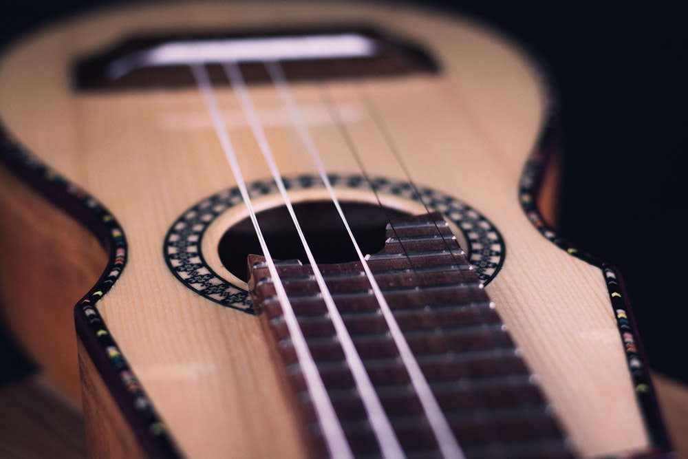 a close up of a ukulele on a black background