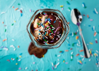 ice cream in glass beside spoon