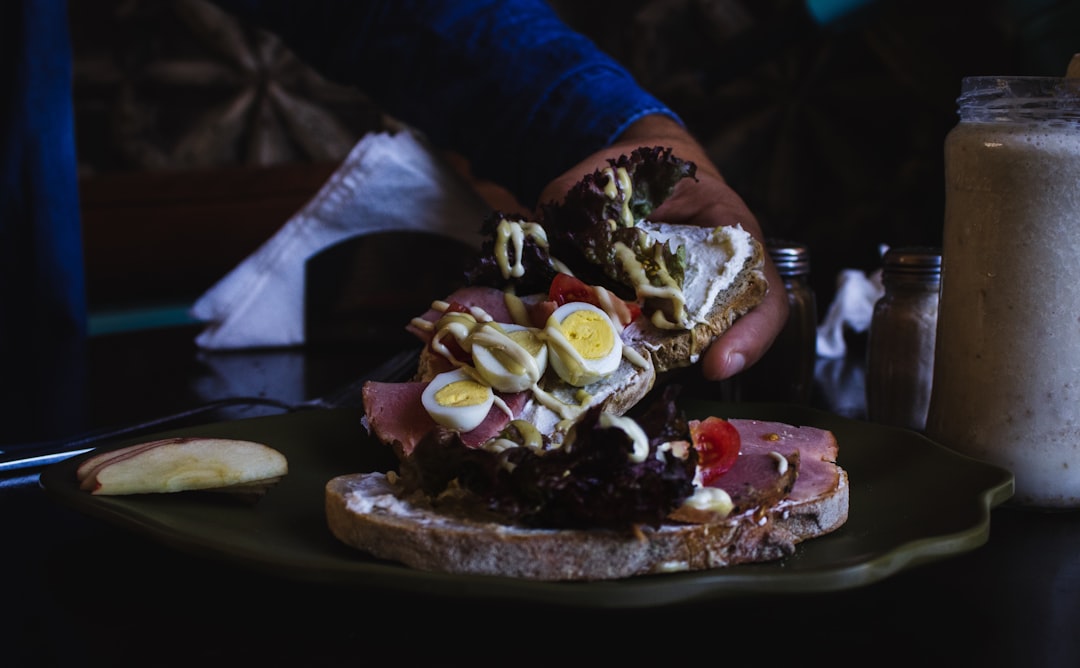 person holding piece of cake,