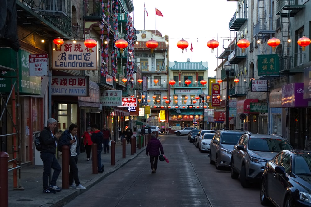 woman walking under red lanterns