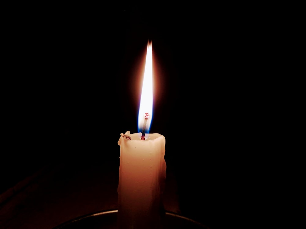 lit candle in focus photography