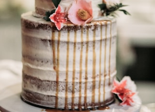 white icing-covered cake with flowers on top