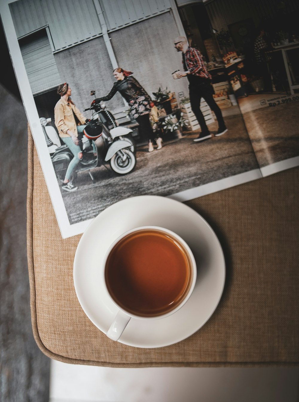 flat lay photography of mug on brown cushion