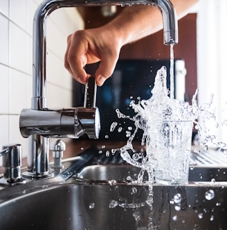 person opening faucet