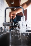 person opening faucet