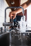 person opening faucet