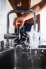 person opening faucet