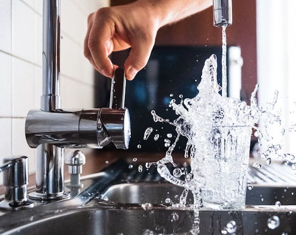 person opening faucet