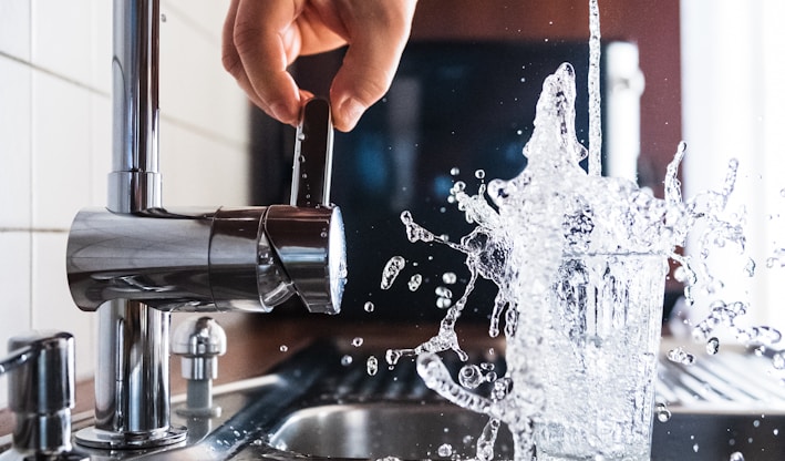 person opening faucet