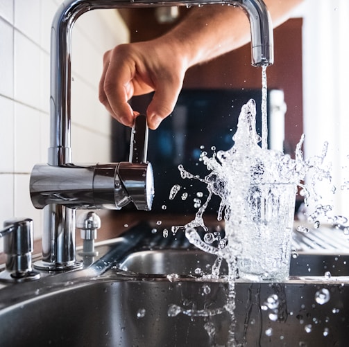 person opening faucet