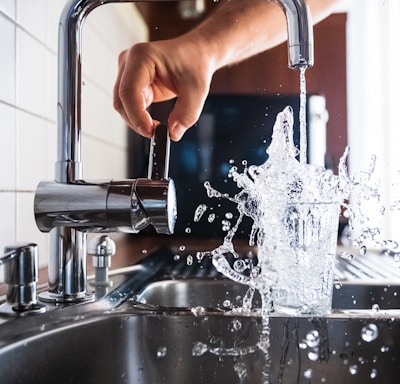 person opening faucet