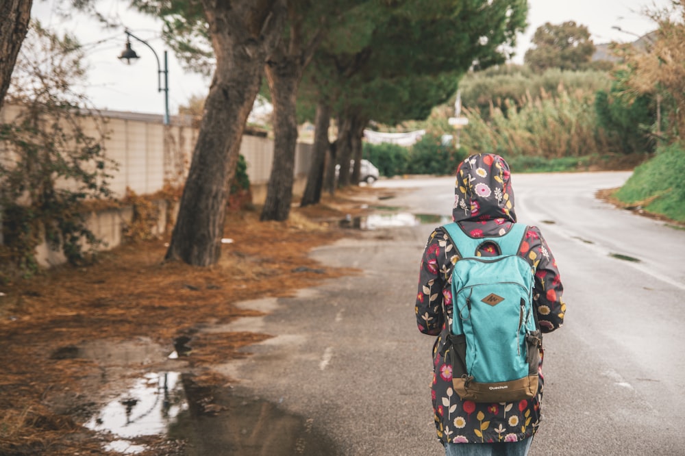 person wearing teal backpack