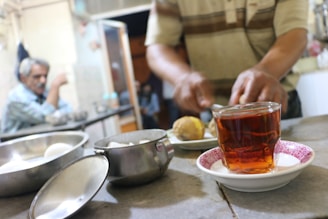 A calm kitchen scene with fresh vegetables and herbal tea on the counter.