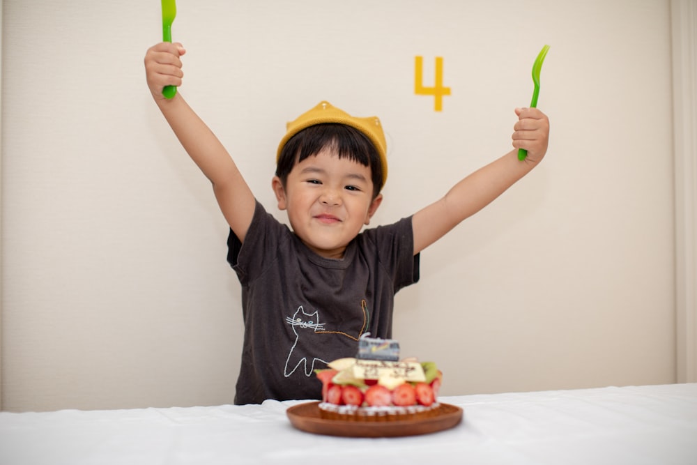 boy raising both his hands