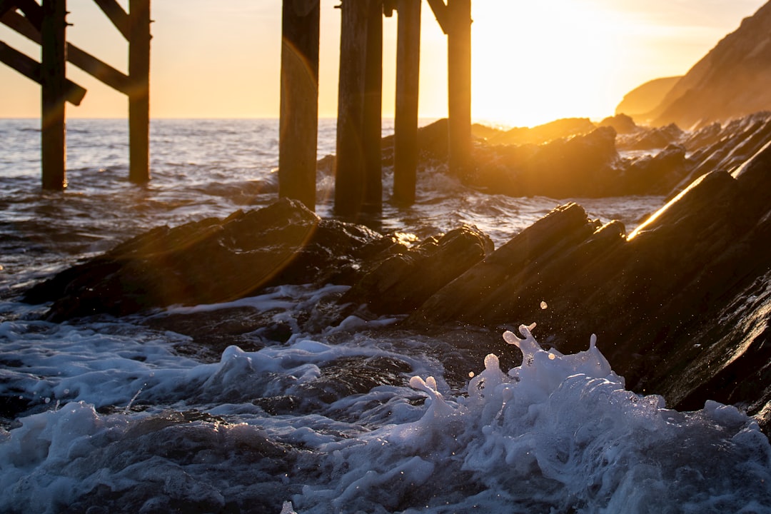 waves on shore during golden hour