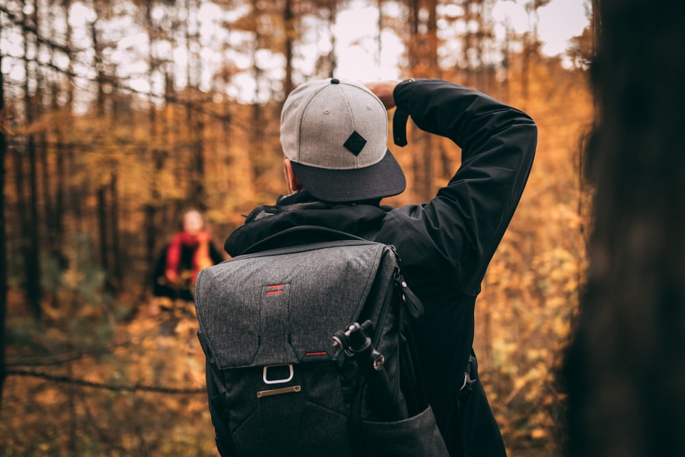 man standing in woods during daytime