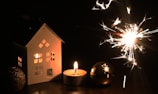 A cozy scene of a home surrounded by twinkling lights.