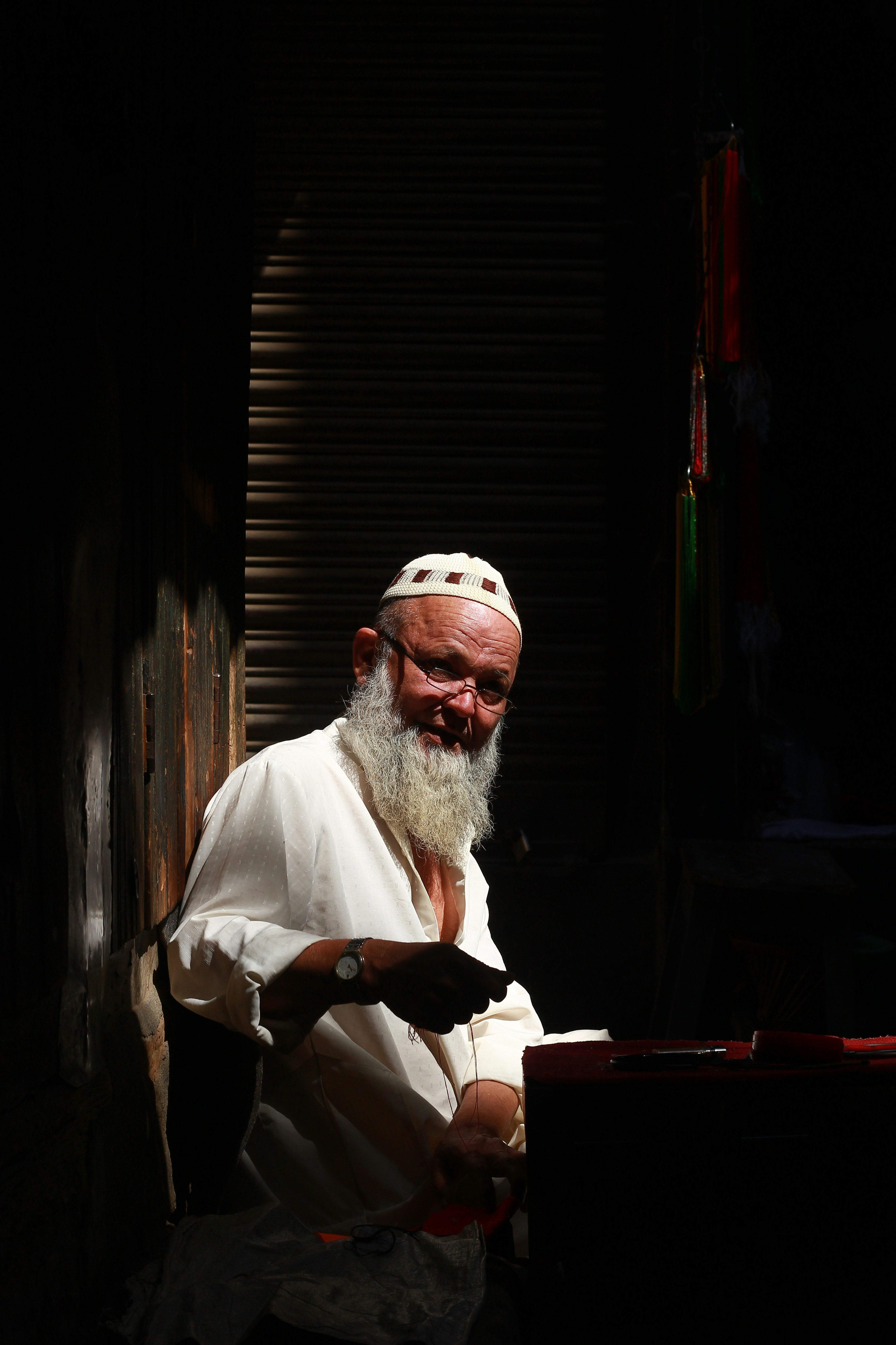 man in white robe sitting on chair