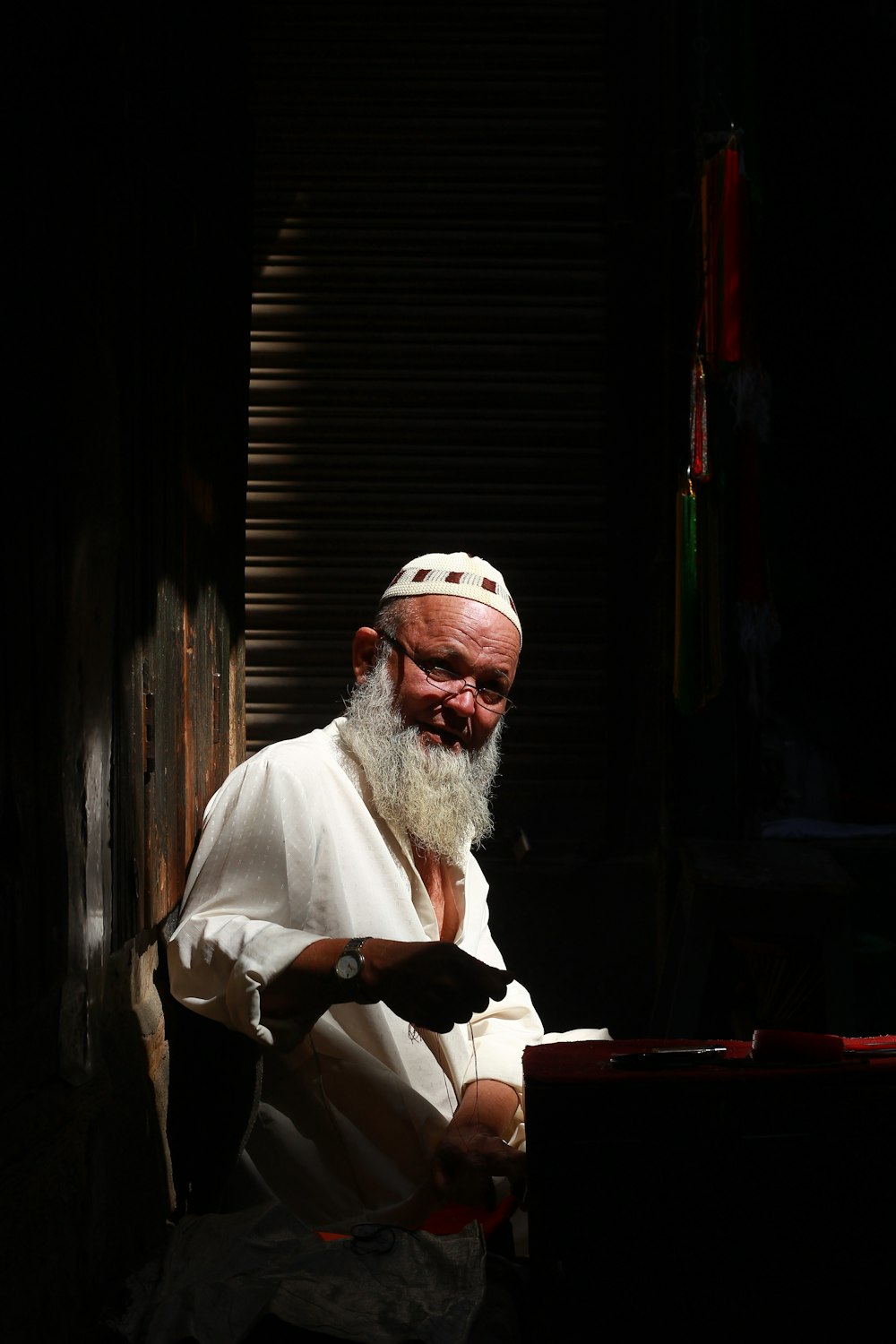 man in white robe sitting on chair