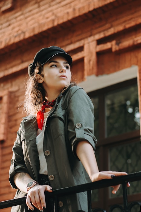 woman leaning on metal fence
