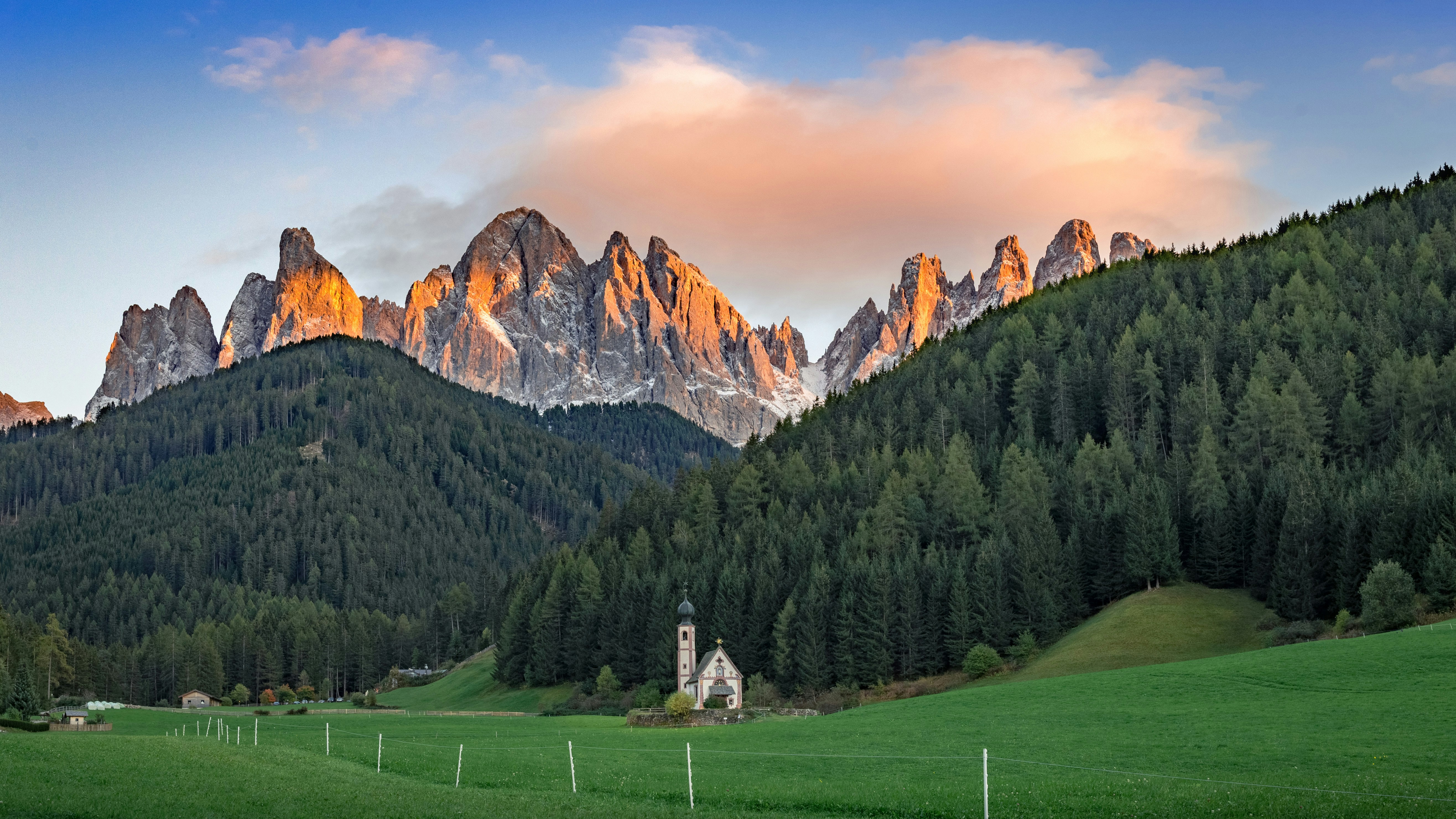 a mountain range with a church in the foreground